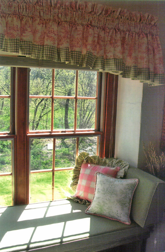 Custom pillows and bedding on a made bed